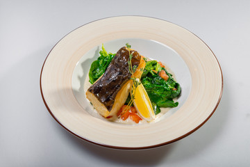 Fried Halibut With Spinach And Lemon Slice