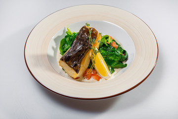 Fried Halibut With Spinach And Lemon Slice