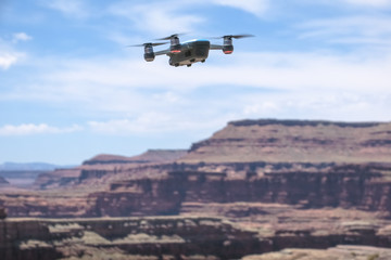 Fototapeta na wymiar Small Drone flying in desert just outside of Canyonlands National Park, Utah