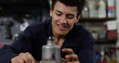 4K Close up portrait happy young mechanic working & smiling at camera