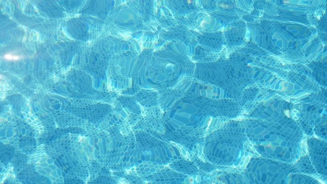 Bright light blue waters in a swimming pool in Turkey in summer in slo-mo  