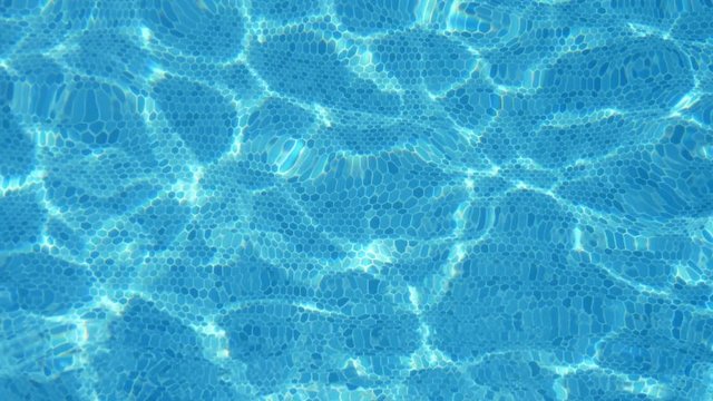 Vibrant celeste waters in a swimming pool in Alanya resort in summer in slo-mo  
