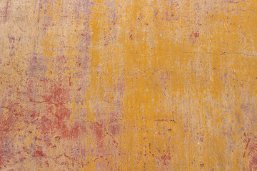 Old cracked weathered shabby red yellow painted plastered peeled wall banner background.