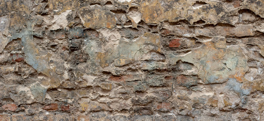 Old brick wall with peel stucco texture. Retro vintage worn wall background. Decayed cracked rough abstract wall surface