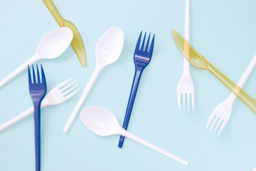 Save the planet, Recycling and ecology concept. Plastic garbage. A photo from above of Plastic disposable spoons and forks on the blue background. Zero waste, environmental pollution. - 278148239
