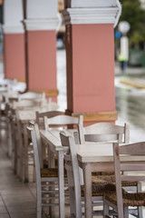Row of empty white wooden chairs