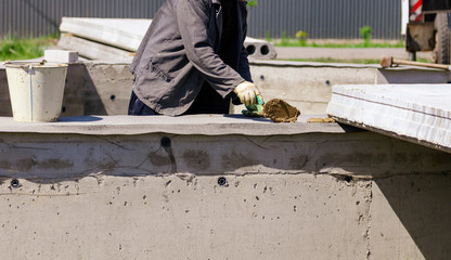 Installing concrete slabs at a construction site at home