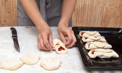 The hostess prepares the pies in the kitchen