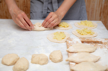 The hostess prepares the pies in the kitchen