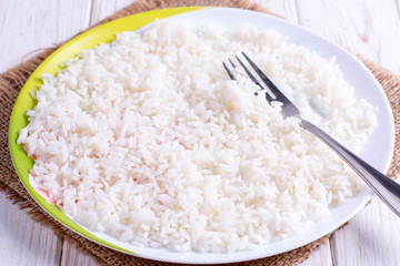 Boiled rice in a bowl with a fork