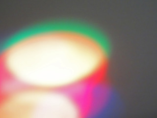 Multicolored circle areas with various colours shades superimposes - parts close up from low angle