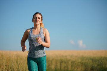 Sport, fitness, health care, cardio training. Active woman with athletic body running in the...