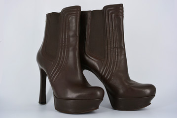 Brown women's stylish autumn boots made of genuine leather with high and thin heels.