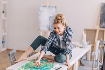 positive girl preparing a surprise for lover . happy blond woman drawing boyfriend