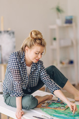 girl is enjoys avant-garde style of painting. close up photo. flight of fancy. girl preparing a...