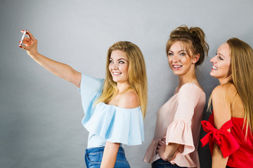 Obraz premium Fashionable women taking selfie