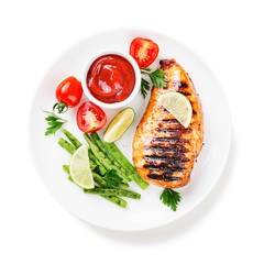 Grilled chicken breast with lemon and green beans . isolated on white background