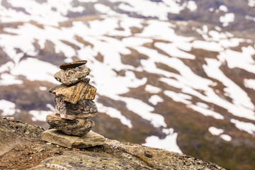 Stone stack and snowy mountain tops, Dalsnibba Norway