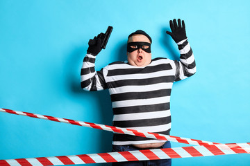 murder being afraid by police. unexpected moment. close up portrait.thief being arrested by...