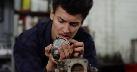 4K Mechanics student with no practical skills looking at camera with exasperation