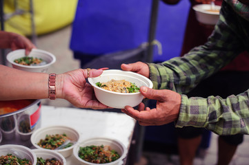 Food sharing in human societies can help homeless people : concept Sharing Food With Homeless