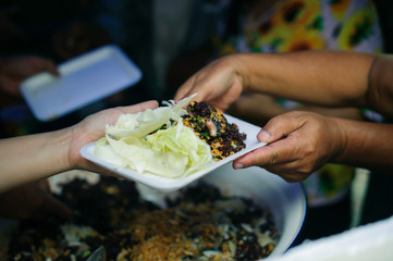 Help serving free food to the poor Needy : concept Sharing Food With Homeless