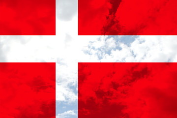 beautiful national flag of Denmark on soft silk with soft folds, close-up, copy space on a translucent blue sky background