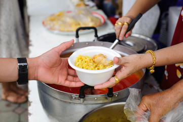 Charity food is free for people in slums : Hands of volunteers serves free food to the poor and needy in the city