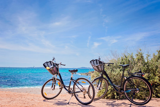 Two bicycles isolated on paradisiacal beach in Mallorca