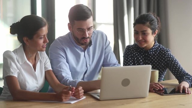 Helpful businessman mentor teacher coach teaching diverse female interns
