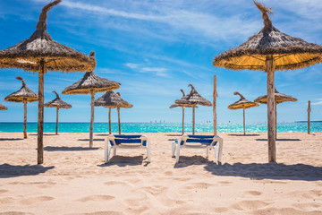 Two beach chair isolated on paradisiacal beach on a sunny day