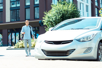 Fototapeta premium Successful businessman walking to his car in the morning