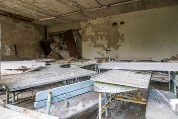 Decaying building of school in Pripyat, abandoned after the nuclear explosion in Chernobyl, Ukraine. Building is slowly falling apart, everything is rotten and destroyed. Ghost town