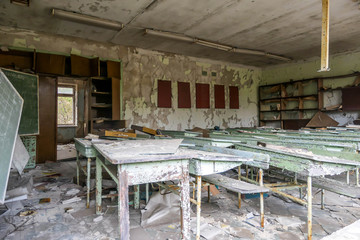 Decaying building of school in Pripyat, abandoned after the nuclear explosion in Chernobyl, Ukraine. Building is slowly falling apart, everything is rotten and destroyed. Ghost town