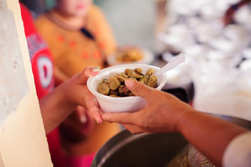Beggar begs food from donors : The Concept of Donating Food to the Poor in Society