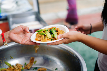 Beggar begs food from donors : The Concept of Donating Food to the Poor in Society