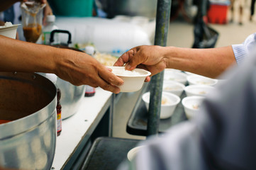 Volunteers Share Food to the Poor to Relieve Hunger : Beggar begs food from donors