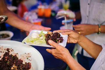 concepts of poverty in Asian society : Volunteers Share Food to the Poor to Relieve Hunger