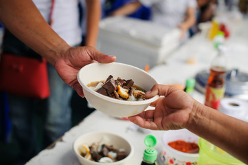 concepts of poverty in Asian society : Volunteers Share Food to the Poor to Relieve Hunger
