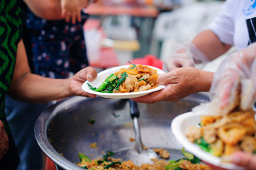 Hands of beggars accepting food from the hands of volunteers who come to help free food breaks : Social Problems of Poverty Helped by Feeding
