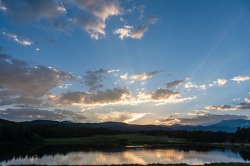 Sunset over a small Lake in the Colorado Rocky Mountains, known as Los Lagos Reservoir Number three. Near Kelly Dahl Campground and the Town of Nederland, CO.