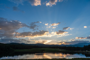 Naklejka na ściany i meble Sunset over a small Lake in the Colorado Rocky Mountains, known as Los Lagos Reservoir Number three. Near Kelly Dahl Campground and the Town of Nederland, CO.