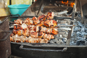Barbecue fries in the coals. Meat and beef at the field kitchen festival.