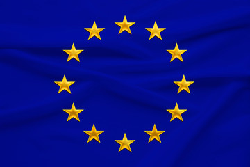 stylized European Union flag, symbol of united Europe on soft silk with soft folds, close-up
