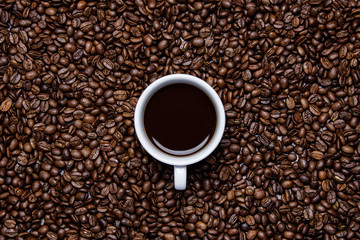 cup of coffee on coffee beans background