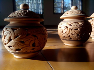 close up pottery brown color with light coming from the side on floor