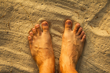 Man feet on sea sand,  Vacation on ocean beach, Summer holiday.