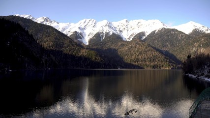 Fototapeta premium Sunset on an alpine lake Ritsa in spring. Abkhazia. Timelapse
