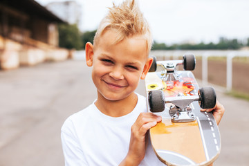 Handsome skater posing with skateboard on his shoulders © Виктория Карлова