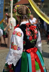 Polish girl in traditional costume from lowicz region while joins annual Corpus Cristi procession,...